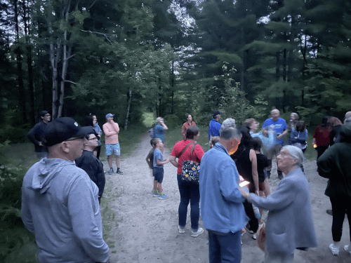 People arriving and greeting each other in the forest
